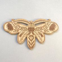Etched wooden moth decoration
